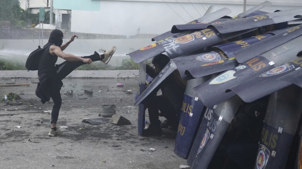 Philippine police arrested dozens after a violent clash near presidential palace, in photos