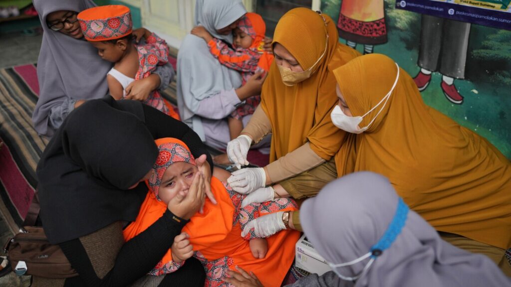 Photos show the efforts to curb a measles outbreak in Indonesia