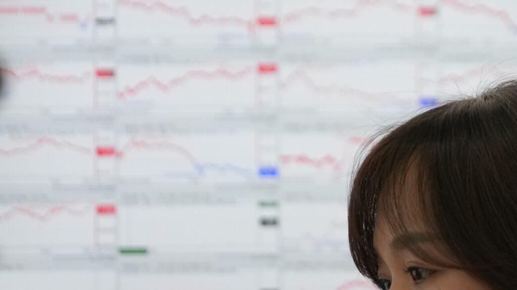 Asian shares are mixed, while gold and silver hit record highs